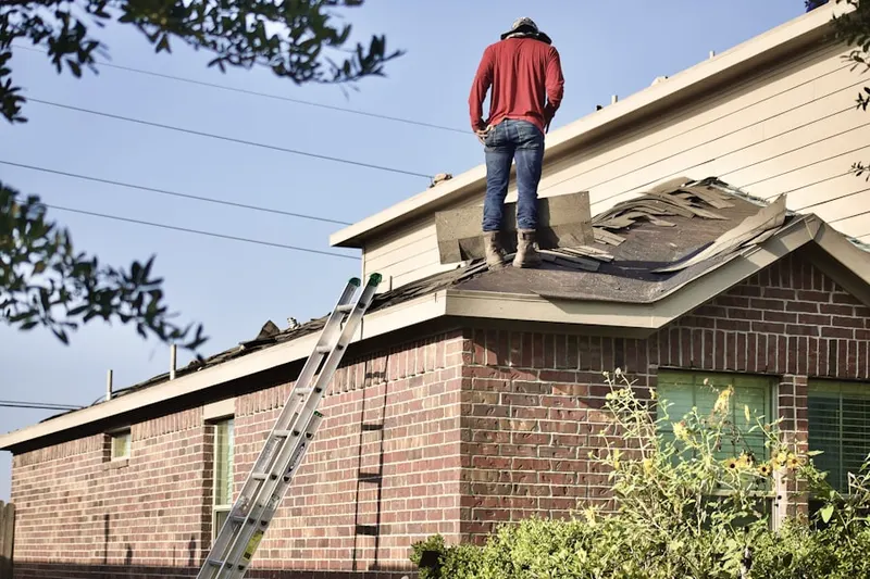 Professional roofer working on a residential roof in Brooklyn